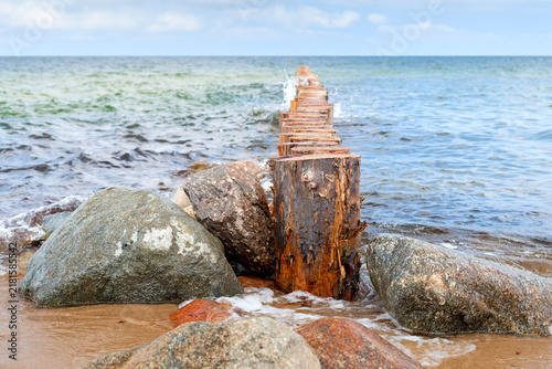 Wooden groins and rocks at Baltic sea