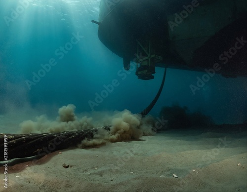 Underwater cable installation on sandy ocean floor