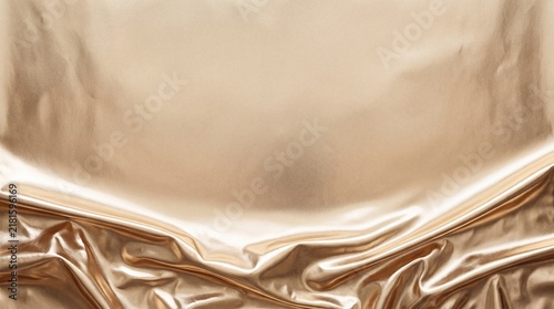 A luxurious, rippling golden fabric cascades elegantly, creating a rich texture and a sense of opulent grandeur, perfect for a sophisticated backdrop.