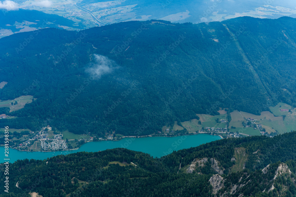Obraz premium Misty landscape with mountain lake in nature. Mountain peak aerial view. Aerial misty landscape. Scenic nature over lake. Scenic mountain lake. Aerial view of mountain landscape. Landscape panorama