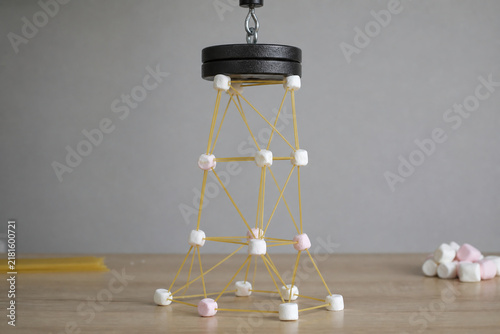Spaghetti marshmallow tower under weight test