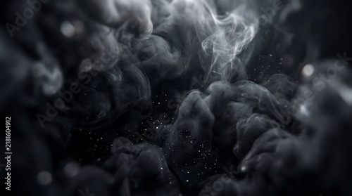 Swirling plumes of dark gray smoke rise elegantly against a black background with glowing white dust particles floating throughout motion