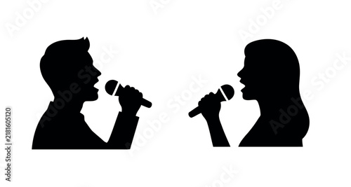 Silhouettes of a man and woman singing into microphones.