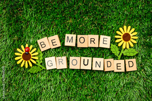 Naklejka Be more grounded sign on grass