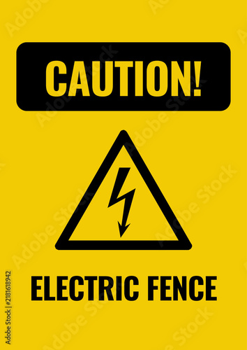 Fotografie Yellow caution sign warning of an electric fence, indicating risk of electric shock and advising people to keep away from energized barriers