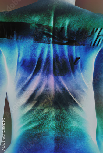 A woman displays her back with a surreal inverted infrared effect