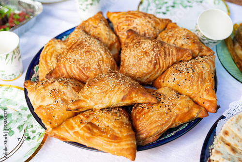 Golden triangular samsa pastries with sesame seeds