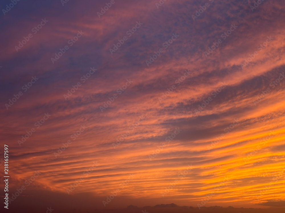 Fototapeta premium Dramatic Orange and Purple Sunset Sky with Colorful Clouds and Copy Space