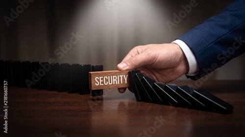 Obraz na płótnie Security block stops domino effect, business risk management concept