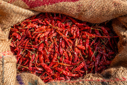 фотографія Overhead view of dried red chilies in a burlap sack