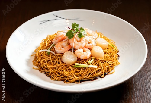 Shrimp lo mein served in a white ceramic bowl with lo mein delicious oriental restaurant