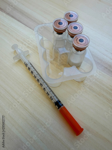 Reta, retatrutide peptide in a vial and bacteriostatic water on a wooden background