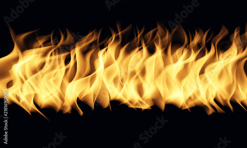 Cuadro en lienzo Bright orange and yellow fire flames burning in a horizontal line on a dark back