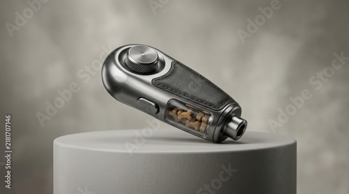 Portable electric grinder with sleek metallic finish and transparent bean chamber rests atop circular stone pedestal in studio setting.