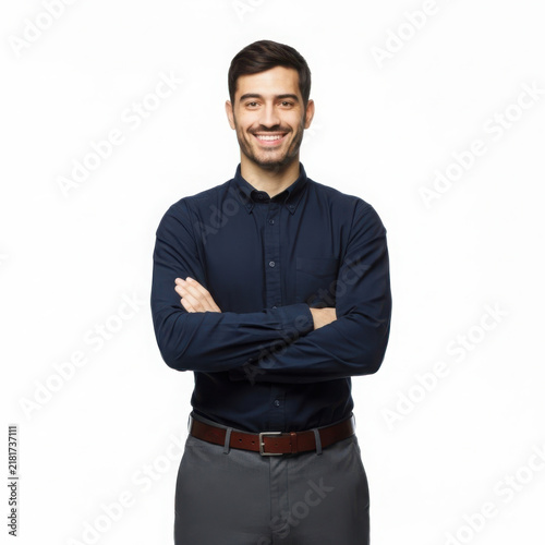 Confident smiling man with arms crossed professional studio portrait