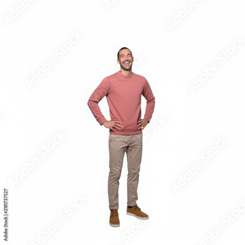 Smiling man in casual pink sweater and tan pants with hands on hips