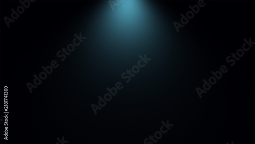 Soft blue light beam shining down in a dark room
