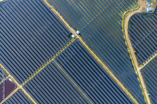 vast floating solar farm and wind turbines over water