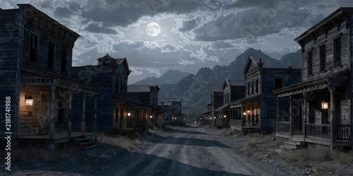 Old western town at night with full moon and dramatic cloudy sky over mountains.