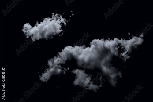 Two fluffy white clouds floating in the dark night sky