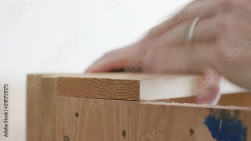 woodworker using a hammer then an electric nail gun on a project