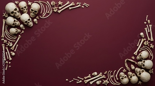 Decorative border frame made of human skulls and bones on a dark red background for halloween
