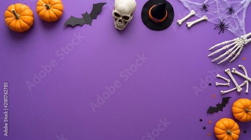Halloween background with pumpkins skull skeleton hands and bats on a vibrant purple surface with copy space