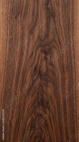 High resolution dark walnut wood grain texture featuring elegant natural patterns and rich brown tones for luxury interior design backgrounds and professional architectural visualization