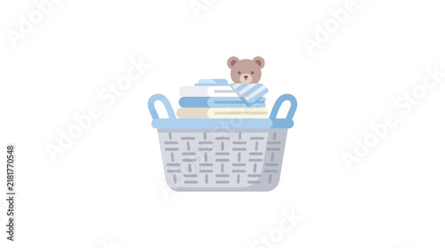 Baby laundry basket with folded clothes and a teddy bear for nursery organization
