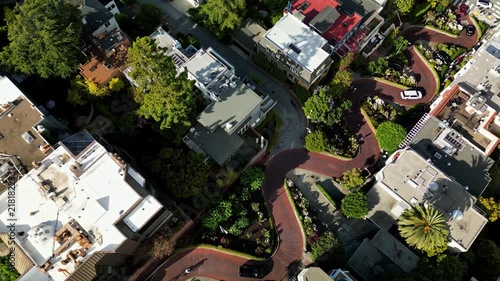 High angle aerial view of cars driving down the famous crooked lombard street in san francisco, california, on a sunny day with green gardens