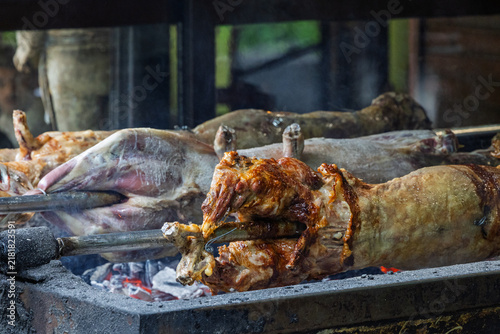 Whole Roasted Lamb On Spit Over Hot Coals At Traditional Outdoor Barbecue Roast