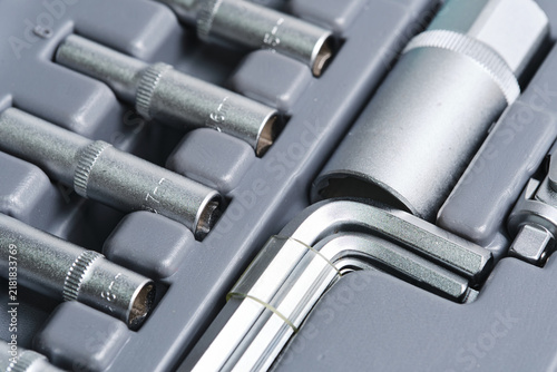 Quadro su tela Detailed close up metal hex keys, sockets, and ratchets arranged in organized gray toolbox