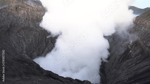 White volcanic gas and smoke billowing from the active crater of mount bromo in indonesia