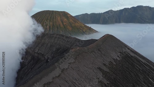 Stunning aerial perspective of the active mount bromo crater with smoke and mount batok nearby
