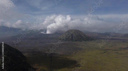 Mount bromo emitting a plume of white smoke in bromo tengger semeru national park, east java