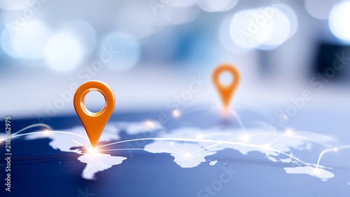 Location pins connected across a world map represent global navigation and intelligent logistics for worldwide transportation networks.
