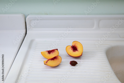 Sliced peach on white counter