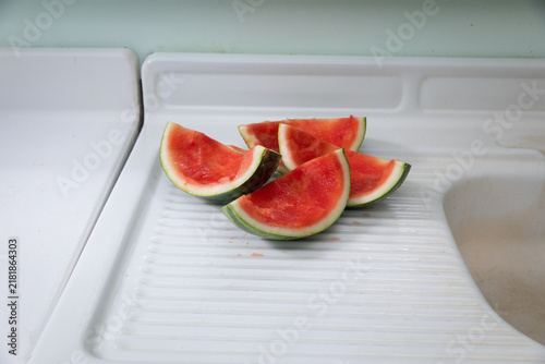 watermelon rinds on white metal counter 