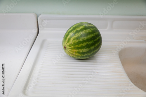 whole watermelon on white counter