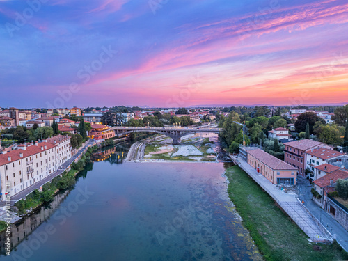 Foto Aerial push in view of Ponte Generale Medici over Brenta river at sunset in Bass