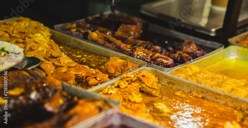Принти на полотні Traditional turkish dessert baklava with honey and nuts in trays on market stall