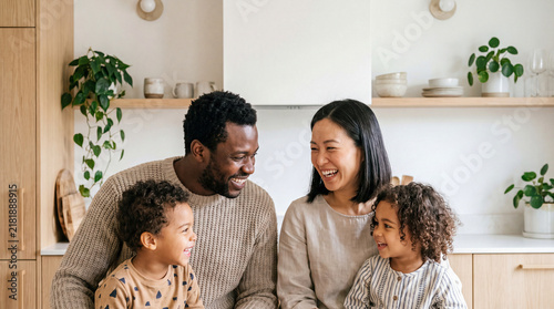 Diverse family laughing and cooking together in a modern kitchen