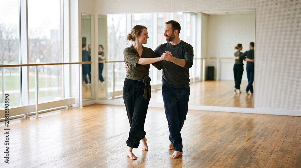 Fototapeta premium couple practicing ballroom dance moves in bright studio with wooden floor