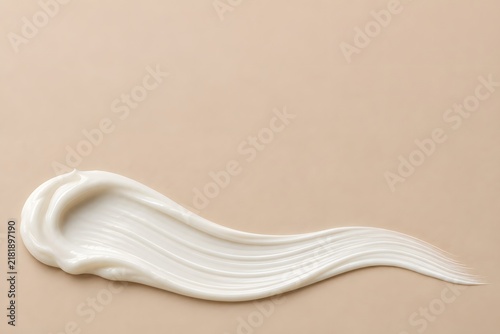 White Skincare Cream Wave on Beige Background with Copy Space Above