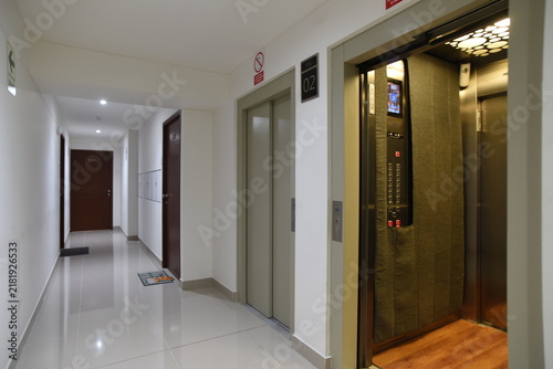 Modern Luxury Hotel Corridor Interior with Wooden Floor, Elegant Doors, Glass Windows and Contemporary Architectural Design