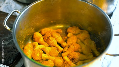 A professional chef frying Chicken in a restaurant for biriyani preparation. 4K closeup view of chicken preparation.