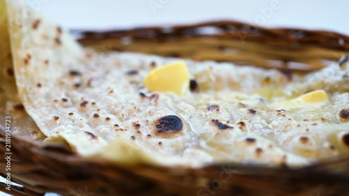 Naan bread on dark background close-up. Paratha and roti. Indian bread 4K video. Chapati and butter naan.