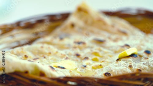 Naan bread on dark background close-up. Paratha and roti. Indian bread 4K video. Chapati and butter naan.