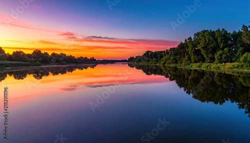Serene lake at colorful sunset.