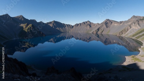  Volcanic Crater Lake Mirroring a Clear Blue Sky
